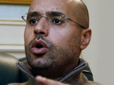 سيف الإسلام القذافي يتوعد بعمل عسكري شامل ضد المعارضة و قوات القذافي تسيطر على الزاوية ورأس لانوف
