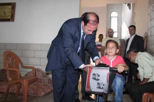 المحافظ كيل يقدم كرسي كهربائي متحرك للطفل أحمد عمارنه