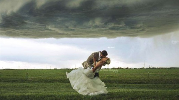 عروسان يخاطران لالتقاط صور زفاف تحت عاصفة قوية
